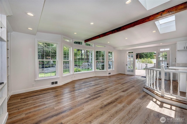 19807 80th Pl W, Edmonds, WA 98026 - unfurnished living room with a skylight, healthy amount of natural light, light wood finished floors, beamed ceiling, and recessed lighting