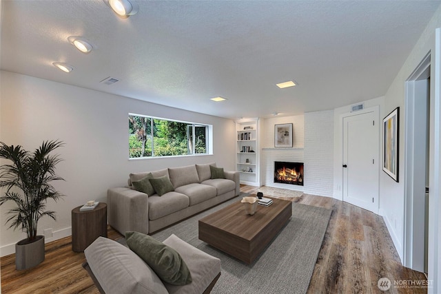19807 80th Pl W, Edmonds, WA 98026 - living area featuring wood finished floors, a textured ceiling, and a fireplace