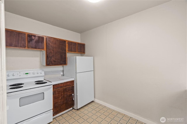 301 W 3rd St, Aberdeen, WA 98520 - kitchen with white appliances, light countertops, and light tile patterned floors