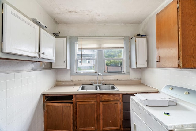 301 W 3rd St, Aberdeen, WA 98520 - kitchen featuring washer / dryer, light countertops, tile walls, and brown cabinets