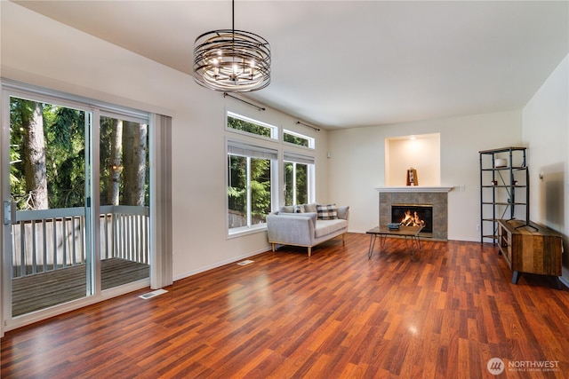 3409 49th St NE, Tacoma, WA 98422 - living room featuring healthy amount of natural light, dark wood-style flooring, a tile fireplace, and a chandelier
