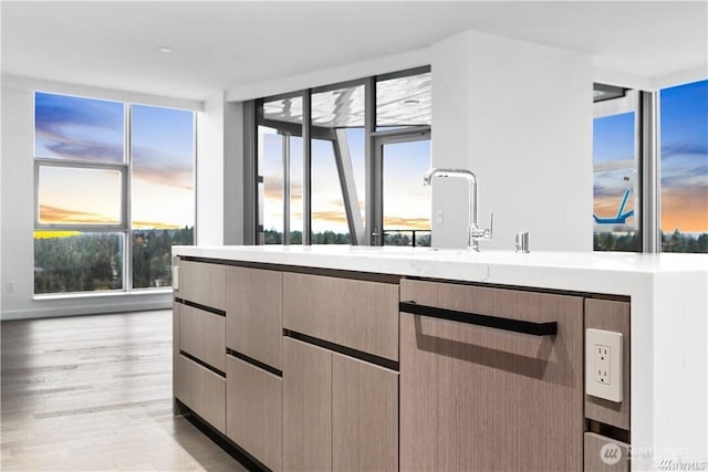 188 Bellevue Way NE Unit 1907, Bellevue, WA 98004 - kitchen featuring light countertops, floor to ceiling windows, light wood-style floors, modern cabinets, and dishwasher