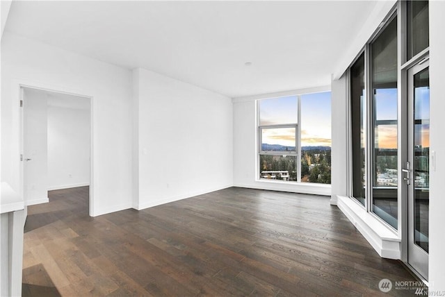 188 Bellevue Way NE Unit 1907, Bellevue, WA 98004 - spare room with dark wood-style floors and baseboards
