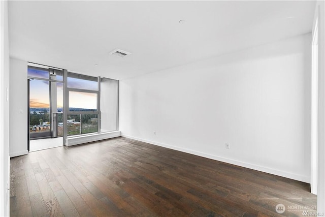 188 Bellevue Way NE Unit 1907, Bellevue, WA 98004 - spare room featuring dark wood-type flooring and baseboards