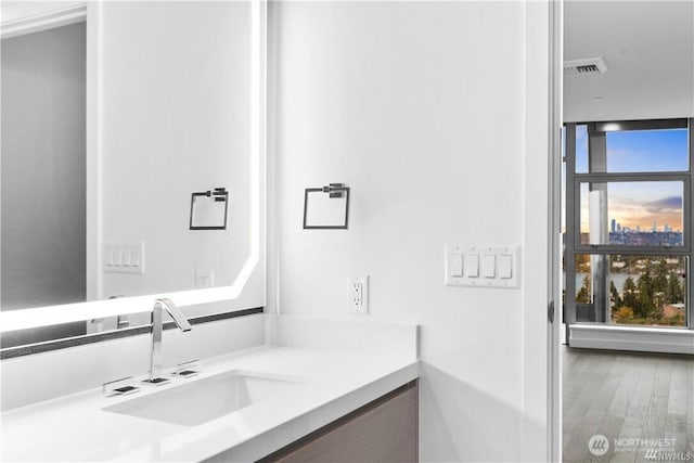 188 Bellevue Way NE Unit 1907, Bellevue, WA 98004 - bathroom featuring vanity, wood finished floors, and floor to ceiling windows