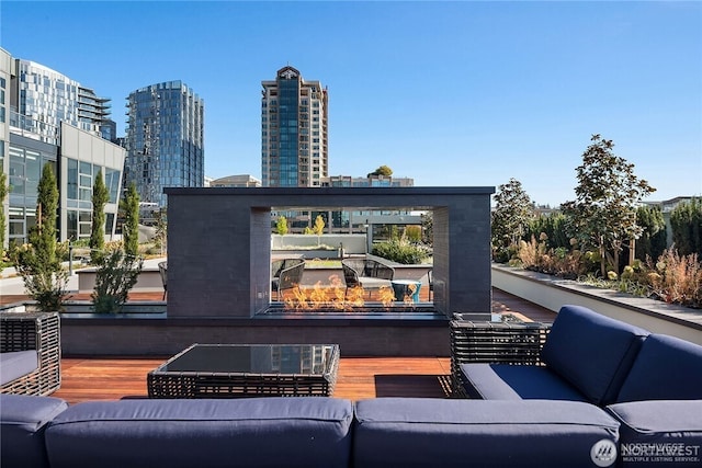 188 Bellevue Way NE Unit 1907, Bellevue, WA 98004 - view of patio with an outdoor living space, a view of city, and a wooden deck