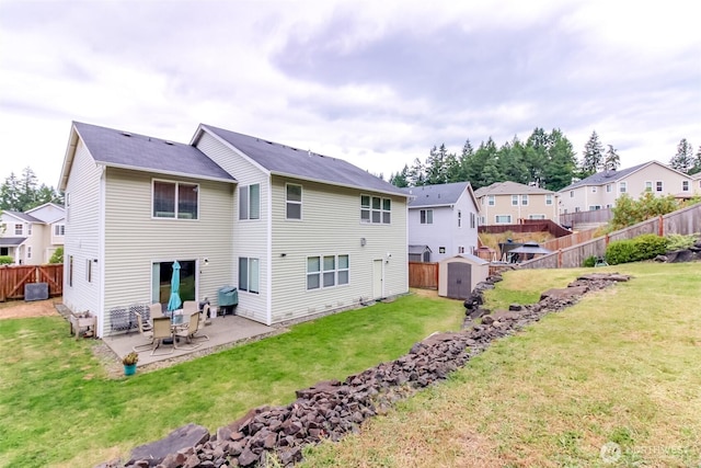1194 Swan Loop, Dupont, WA 98327 - back of house featuring a storage unit, a patio, a fenced backyard, and a residential view
