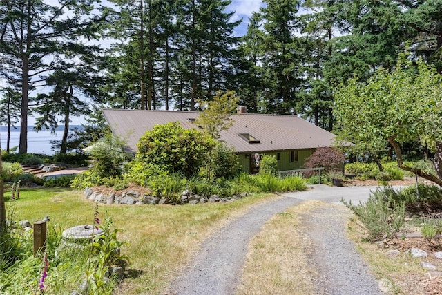 1585 Channel Rd, Lopez Island, WA 98261 - view of property exterior with gravel driveway, a metal roof, and a chimney