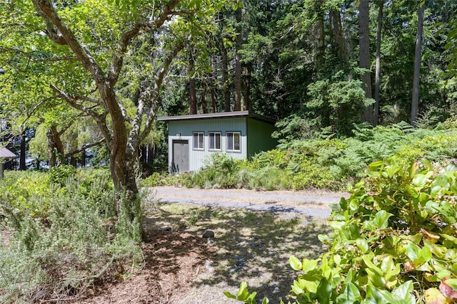 1585 Channel Rd, Lopez Island, WA 98261 - view of front of home featuring an outbuilding and a wooded view