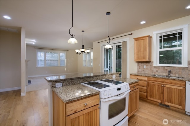 2605 Fir Crest Blvd, Anacortes, WA 98221 - kitchen with white appliances, tasteful backsplash, a chandelier, a center island, and light wood-type flooring