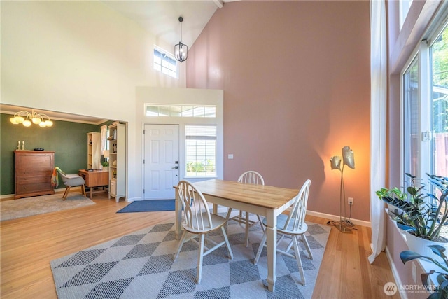 16955 Lookout Mountain Rd SE, Monroe, WA 98272 - dining room featuring wood finished floors, high vaulted ceiling, and a chandelier