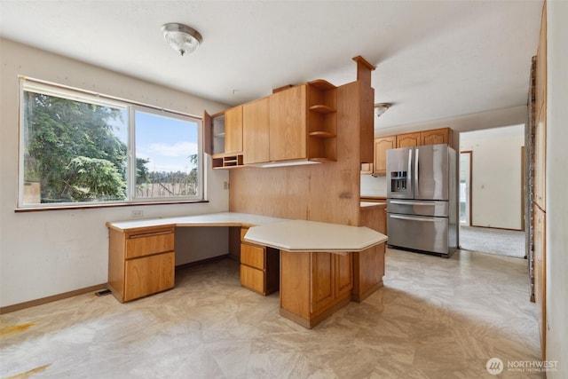 7331 Ridgemont Dr SE, Olympia, WA 98513 - kitchen featuring stainless steel refrigerator with ice dispenser, open shelves, built in desk, light countertops, and light flooring