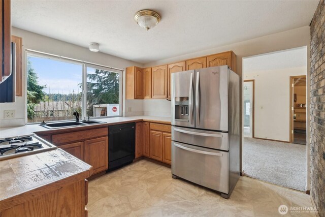 7331 Ridgemont Dr SE, Olympia, WA 98513 - kitchen featuring stainless steel refrigerator with ice dispenser, black dishwasher, cooktop, and light countertops