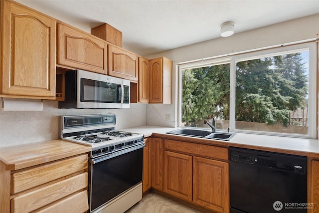 7331 Ridgemont Dr SE, Olympia, WA 98513 - kitchen with dishwasher, white range with gas stovetop, stainless steel microwave, and light countertops