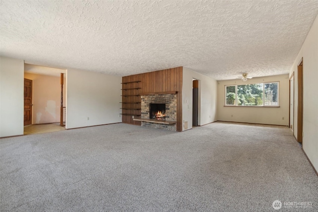 7331 Ridgemont Dr SE, Olympia, WA 98513 - unfurnished living room with a textured ceiling, a fireplace, light colored carpet, and a ceiling fan