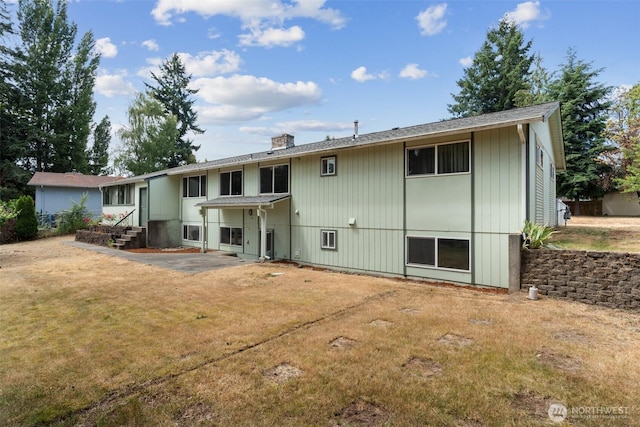 7331 Ridgemont Dr SE, Olympia, WA 98513 - rear view of house featuring a chimney, a yard, and entry steps