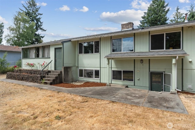 7331 Ridgemont Dr SE, Olympia, WA 98513 - view of front of house with a chimney, a patio area, and entry steps