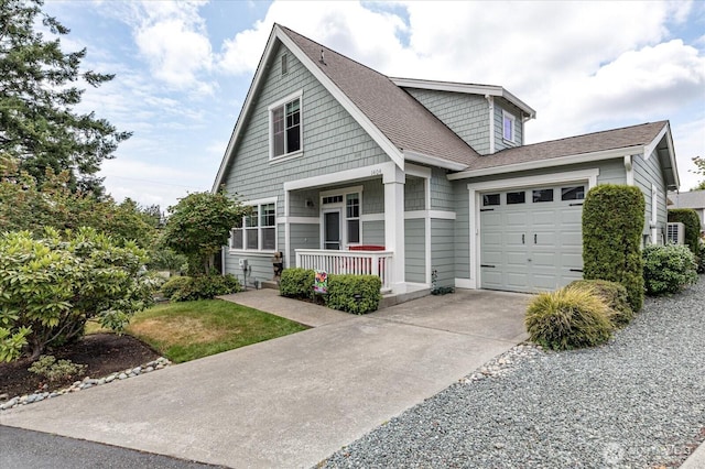 1404 Portside Ct, Freeland, WA 98249 - view of front of property with concrete driveway, covered porch, a garage, and a shingled roof