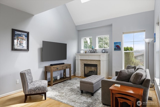 1404 Portside Ct, Freeland, WA 98249 - living room featuring wood finished floors, a glass covered fireplace, and high vaulted ceiling