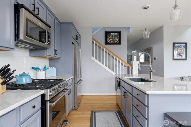 1404 Portside Ct, Freeland, WA 98249 - kitchen featuring high end appliances, light wood-style flooring, decorative backsplash, and light stone counters