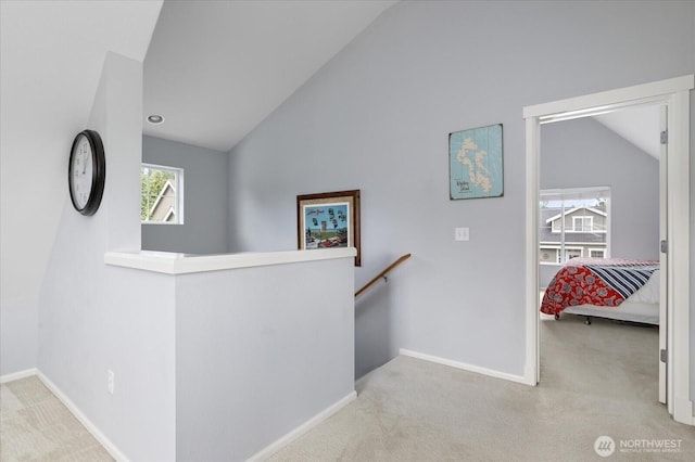 1404 Portside Ct, Freeland, WA 98249 - hall featuring an upstairs landing, vaulted ceiling, and carpet flooring