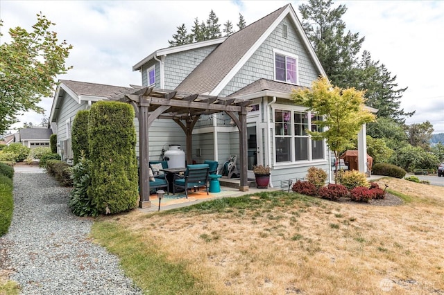 1404 Portside Ct, Freeland, WA 98249 - back of house featuring a pergola, a patio area, a lawn, and a shingled roof