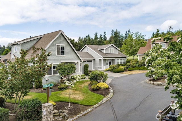 1404 Portside Ct, Freeland, WA 98249 - shingle-style home with driveway and a garage