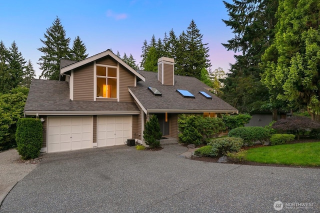 11404 NE 103rd St, Kirkland, WA 98033 - view of front of home with a chimney, driveway, a shingled roof, and an attached garage