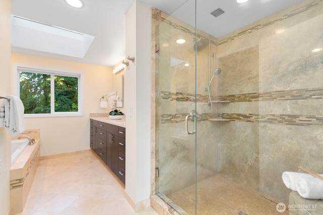 11404 NE 103rd St, Kirkland, WA 98033 - full bathroom featuring a skylight, a stall shower, tile patterned flooring, a bath, and vanity