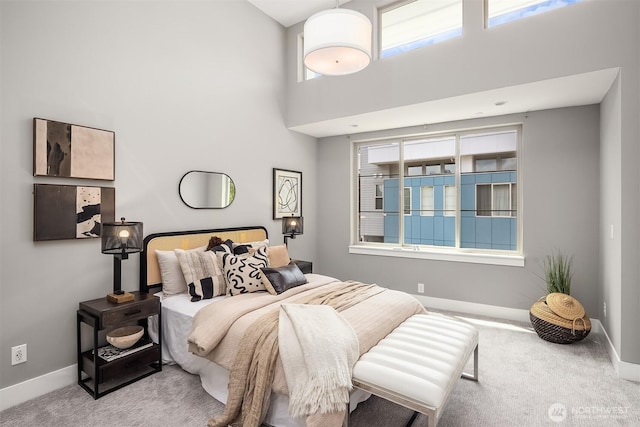 11530 117th Ln NE Unit 2, Kirkland, WA 98034 - carpeted bedroom featuring baseboards and a towering ceiling