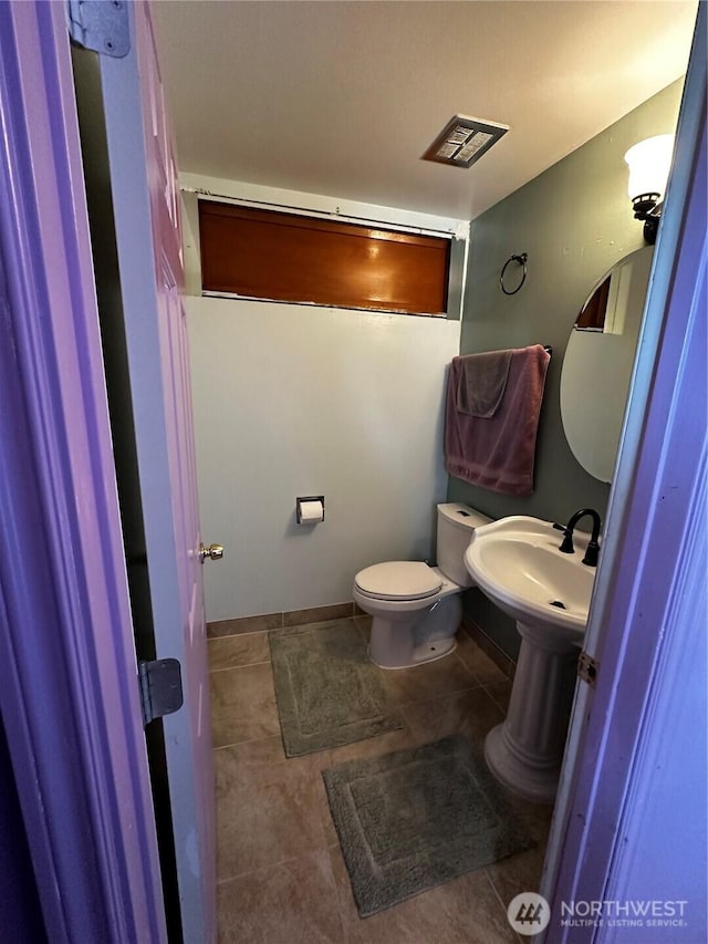 438 Biggs Dr, Moses Lake, WA 98837 - half bathroom featuring toilet and tile patterned flooring