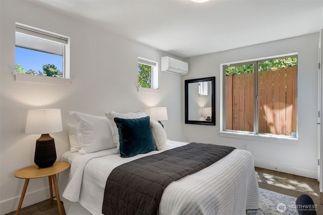 228 24th Ave E Unit A, Seattle, WA 98112 - bedroom featuring a wall unit AC and wood finished floors