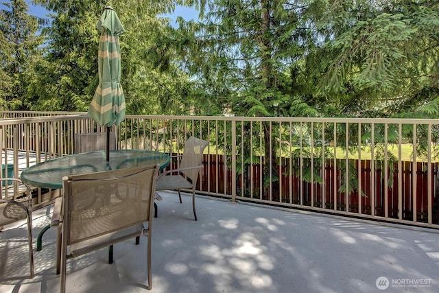 15325 SE 155th Pl Unit Q2, Renton, WA 98058 - balcony featuring outdoor dining space and view of scattered trees