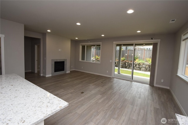 4650 Viridian Ave SW, Port Orchard, WA 98367 - unfurnished living room featuring wood finished floors, a fireplace, and recessed lighting
