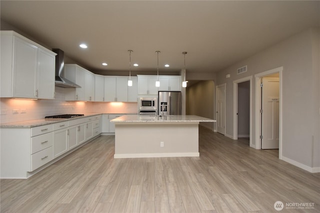 4650 Viridian Ave SW, Port Orchard, WA 98367 - kitchen with appliances with stainless steel finishes, wall chimney range hood, white cabinets, decorative backsplash, and recessed lighting