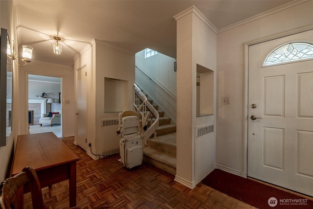 601 Yakima St, Wenatchee, WA 98801 - foyer entrance featuring radiator, crown molding, and stairway