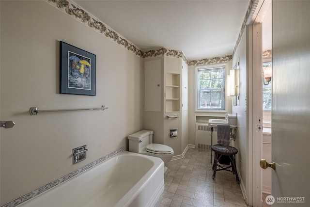 601 Yakima St, Wenatchee, WA 98801 - bathroom with a bath, radiator, and stone finish flooring