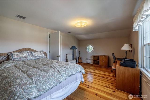 601 Yakima St, Wenatchee, WA 98801 - bedroom with light wood-style flooring, radiator, and an office area