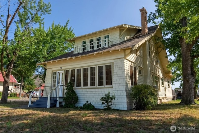 216 4th St E, Tonasket, WA 98855 - view of front of home with a chimney and roof with shingles
