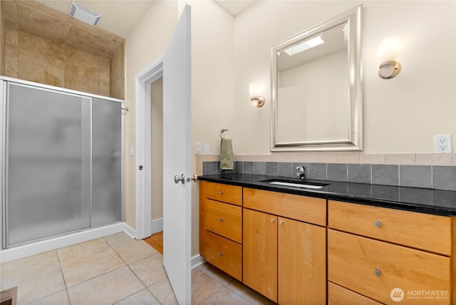 216 4th St E, Tonasket, WA 98855 - full bathroom with vanity, a shower stall, and tile patterned flooring