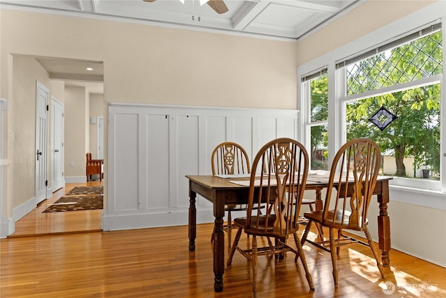 216 4th St E, Tonasket, WA 98855 - dining area featuring a decorative wall, coffered ceiling, wood finished floors, ceiling fan, and crown molding