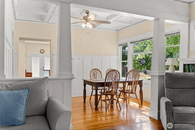 216 4th St E, Tonasket, WA 98855 - dining space featuring decorative columns, coffered ceiling, a decorative wall, wood finished floors, and beam ceiling