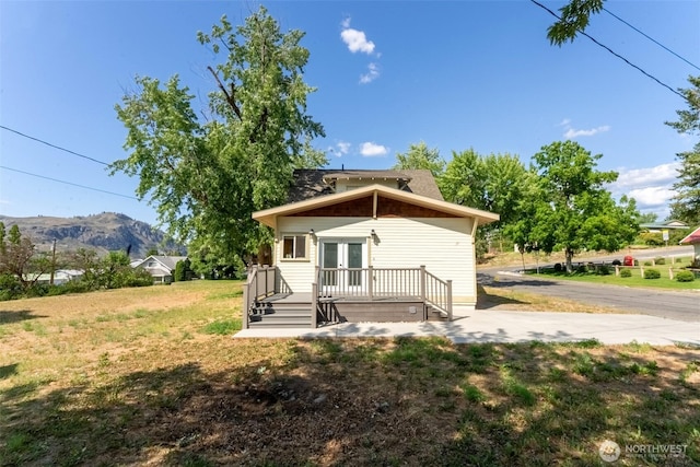 216 4th St E, Tonasket, WA 98855 - back of house featuring french doors, a mountain view, and a yard