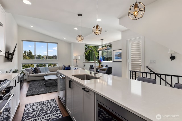 3418 23rd Ave W, Seattle, WA 98199 - kitchen with light countertops, recessed lighting, lofted ceiling, hanging light fixtures, and white cabinetry