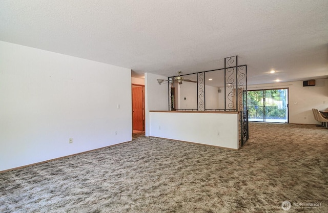 1203 Contra Costa Ave, Fircrest, WA 98466 - unfurnished living room with carpet, a textured ceiling, and recessed lighting