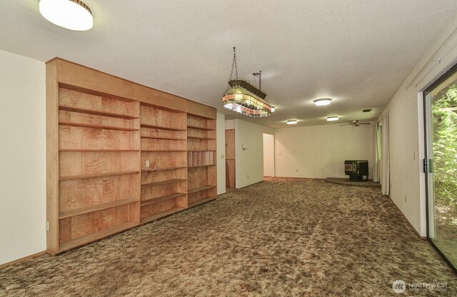 1203 Contra Costa Ave, Fircrest, WA 98466 - carpeted empty room with a wood stove and a textured ceiling