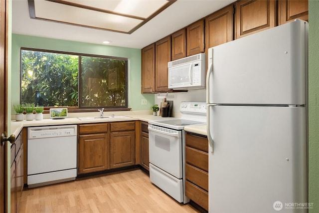 8408 18th Ave W Unit 10-101, Everett, WA 98204 - kitchen featuring white appliances, brown cabinets, light wood-style floors, light countertops, and recessed lighting