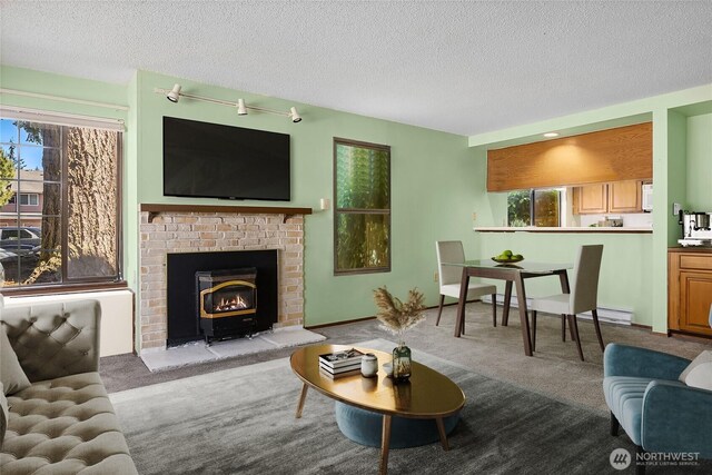 8408 18th Ave W Unit 10-101, Everett, WA 98204 - living area featuring carpet flooring, a textured ceiling, a brick fireplace, and baseboard heating