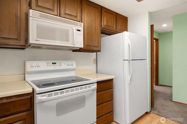 8408 18th Ave W Unit 10-101, Everett, WA 98204 - kitchen featuring white appliances, brown cabinets, light countertops, and recessed lighting