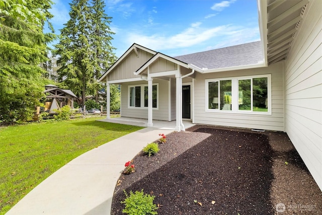 281 Shallow Shore Rd, Bellingham, WA 98229 - view of front of house featuring a front yard, roof with shingles, and a porch